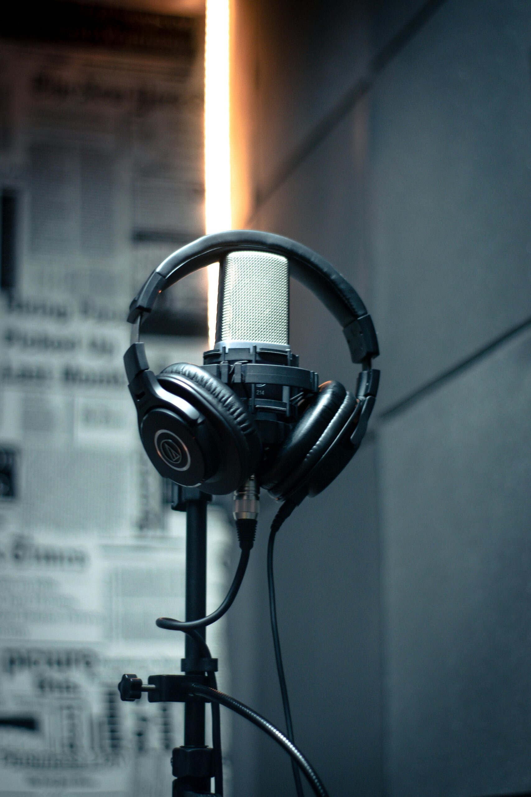 Close-up of a microphone with headphones in a modern recording studio.